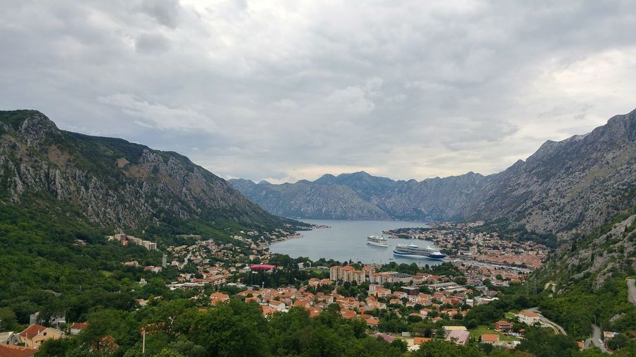 High angle view of townscape by sea against sky
