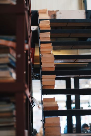 Stack of books on shelves in library