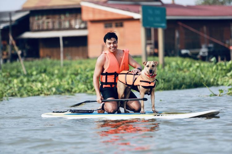 Man and dog on paddling 
