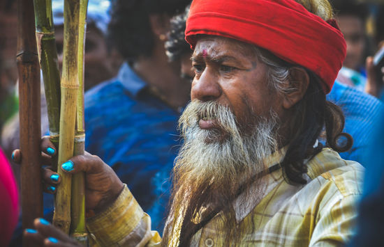 Close-up of senior man holding sticks