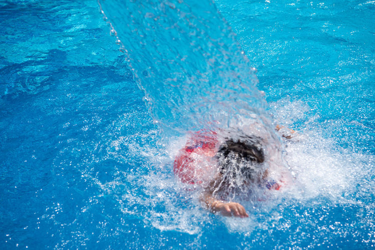 Close-up of boy swimming in pool