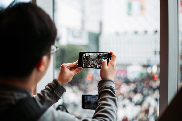 Rear view of man photographing