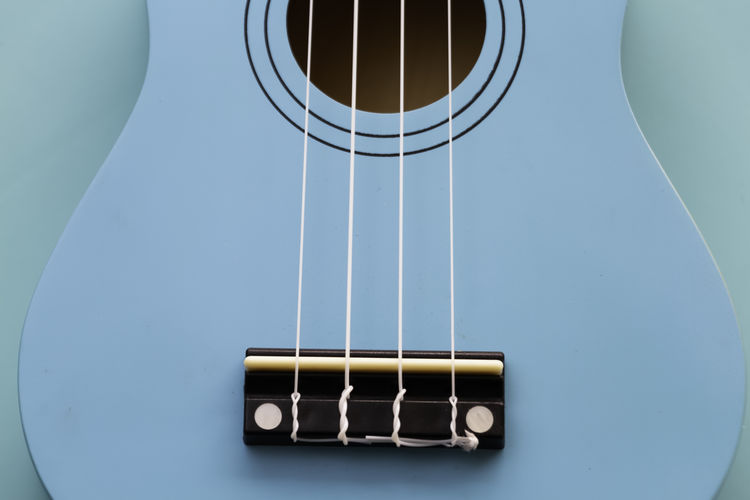 Close-up of guitar against blue background