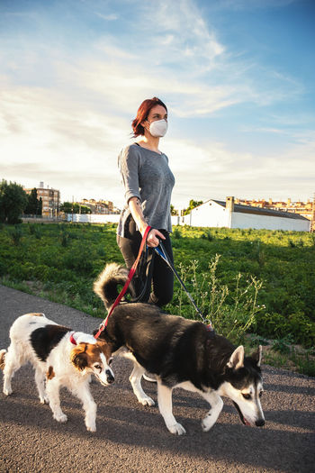 Woman with dog on field