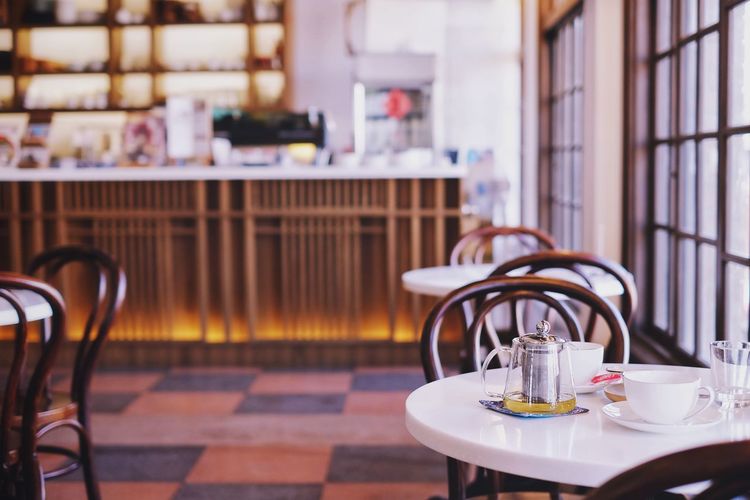 Tables and chairs arranging at restaurant