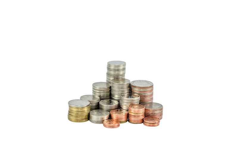 High angle view of coin stack against white background