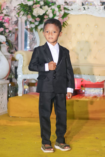 Portrait of boy wearing suit during wedding ceremony
