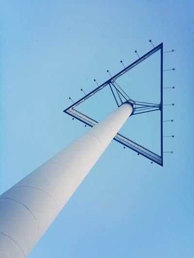 Low angle view of triangle shape billboard against clear blue sky