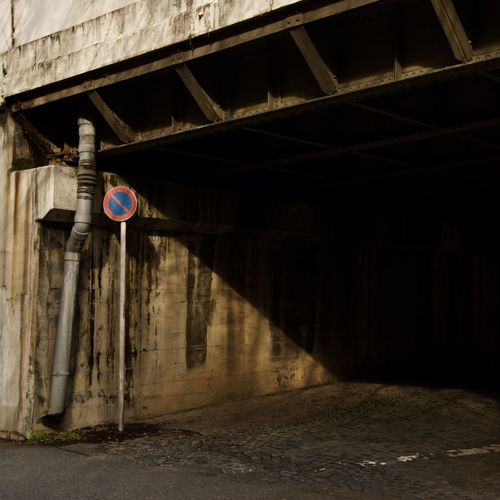 No parking sign on road under bridge