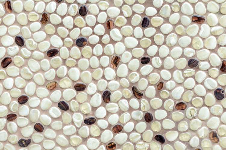 Background of naturally polished white and brown pebbles.