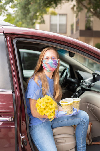 Woman with flowers in car