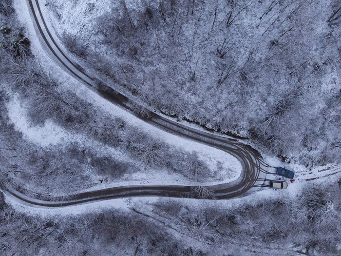 Aerial view of winding road through snowy landscape in asturias mountains in spain. winter time.