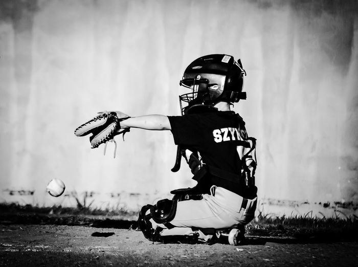 Boy playing baseball on playing field