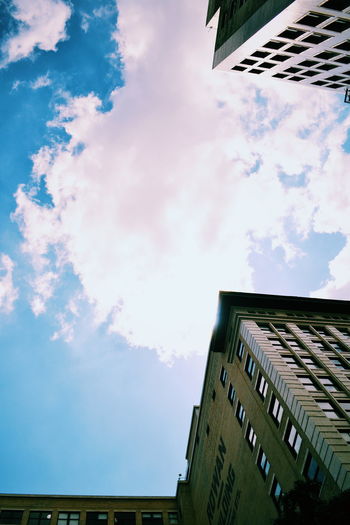 Low angle view of building against cloudy sky