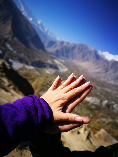 Couple touching hands against mountain
