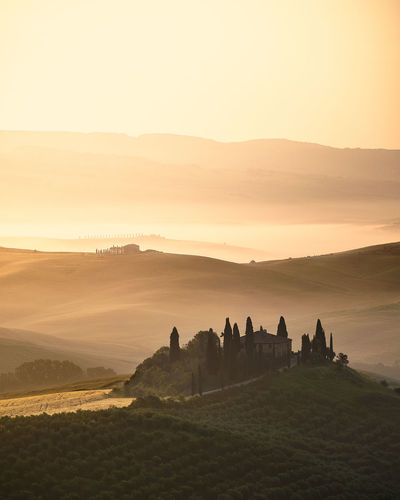 Scenic view of landscape against sky during sunrise