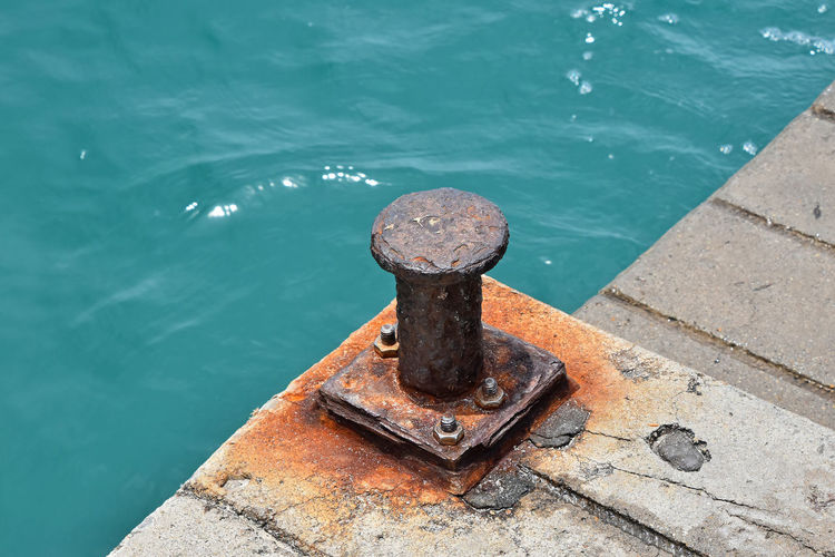 High angle view of metal bollard at harbor
