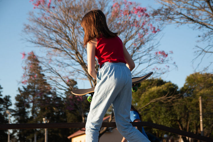 Teenage girl skateboarding