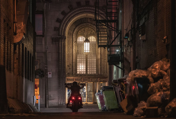 Motor rider riding through dark alley, montréal