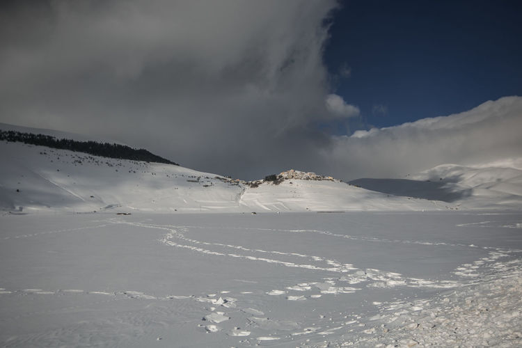 Winter view of castelluccio di norcia mountain village covered by snow in umbria
