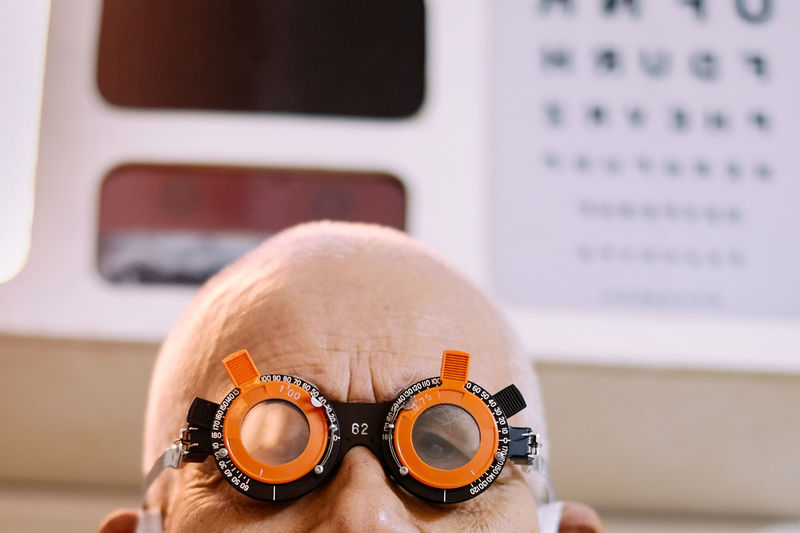Portrait of senior man wearing eye test equipment