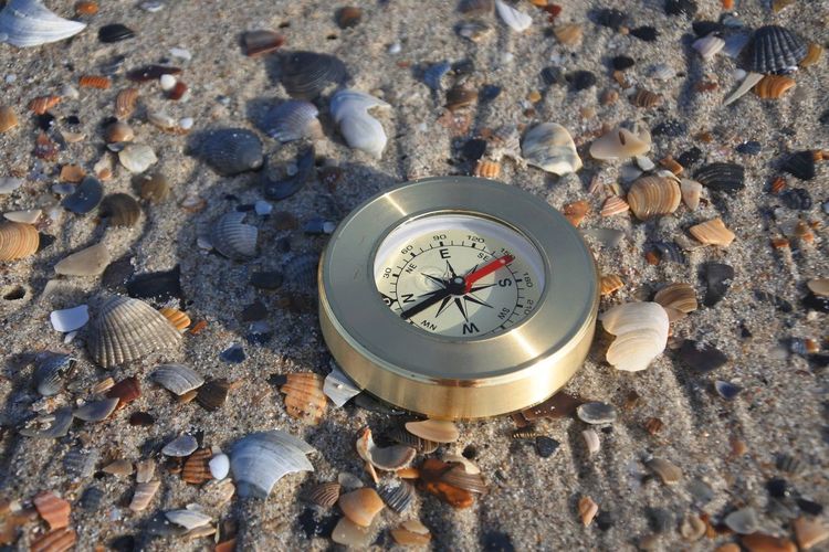 Close-up of clock on pebbles