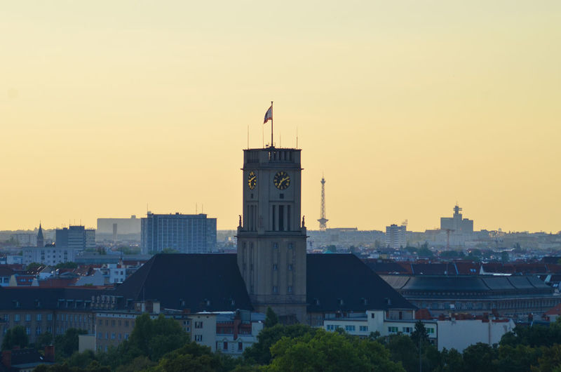 Rathaus schoneberg and city against clear sky at morning