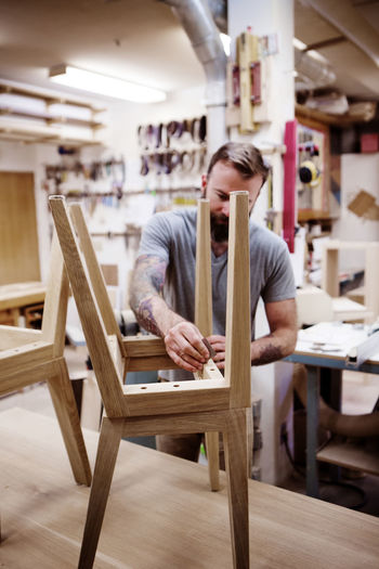 Carpenter polishing stool at workshop