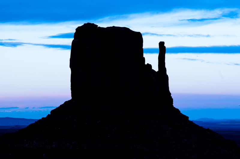 Silhouette of rock formations at seaside