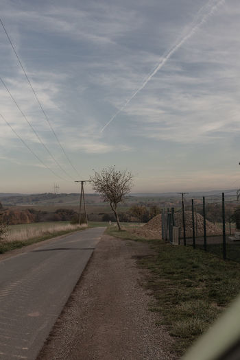 Road by landscape against sky