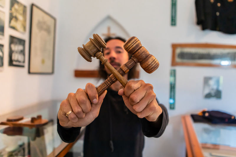 Portrait of man holding gavels