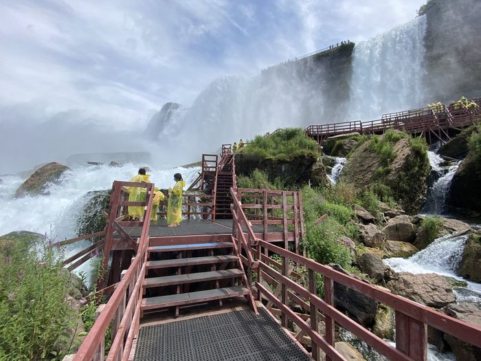 Panoramic view of footbridge over waterfall