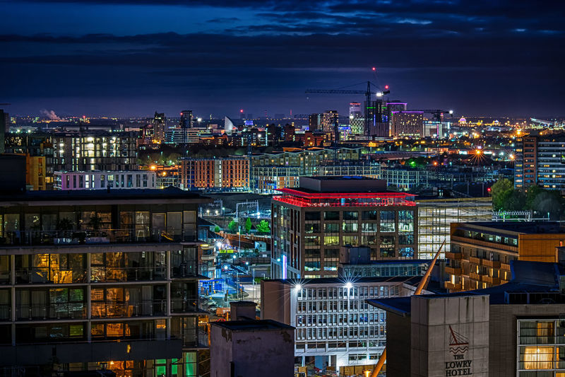 High angle view of city lit up at night