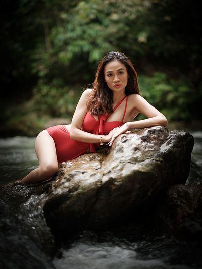 Young woman sitting on rock