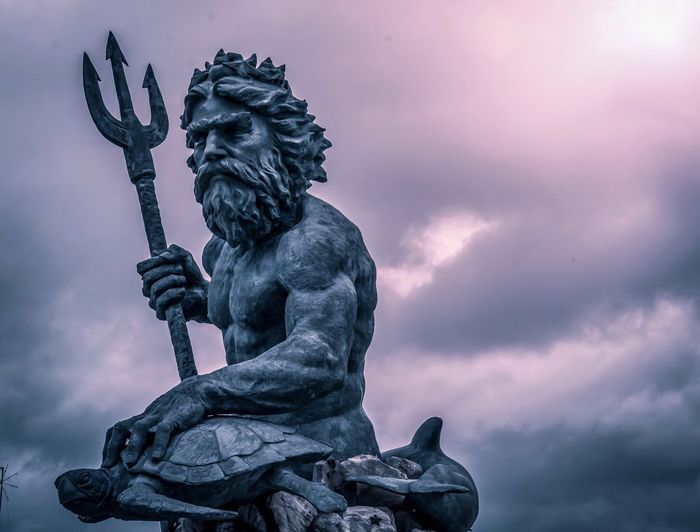 Low angle view of statue against cloudy sky