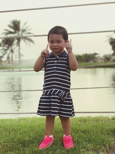 Portrait of girl standing at lakeshore