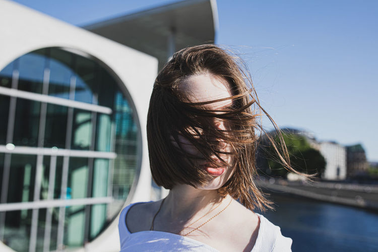 Portrait of woman in front of building