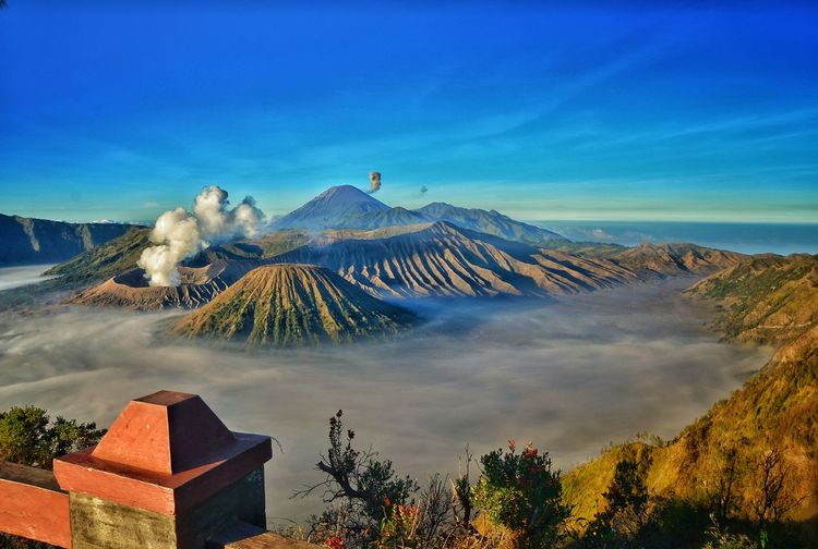 Scenic view of volcanic landscape against blue sky