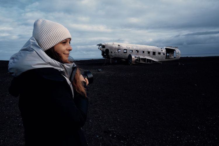 Rear view of woman standing against airplane iceland