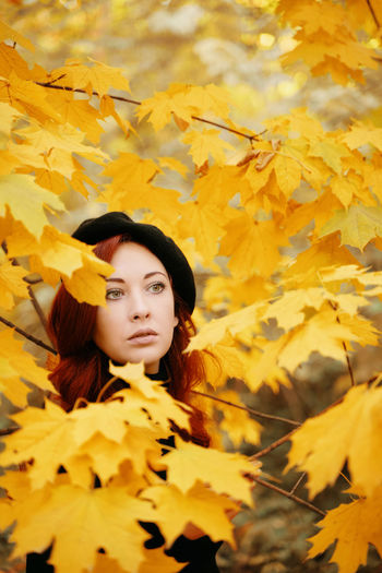 Portrait of woman with yellow leaves during autumn