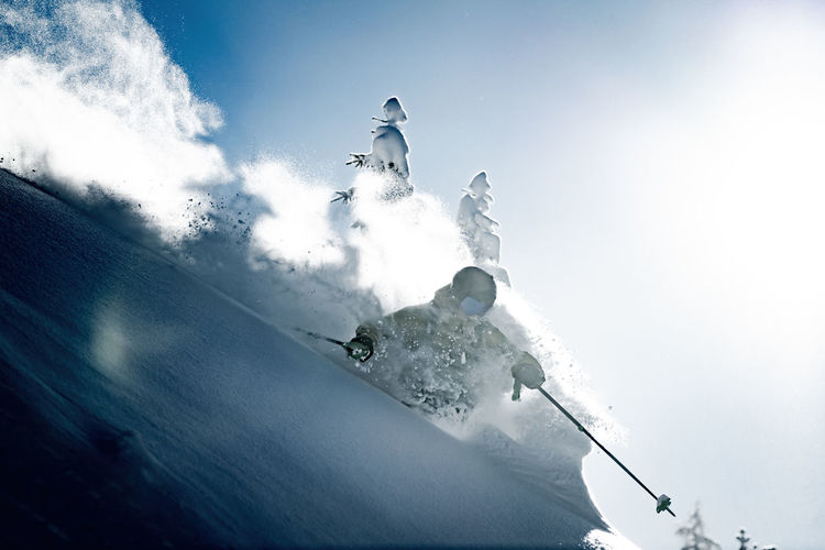 Adult man skiing in deep powder snow in the backcountry, werfenweng, austria.