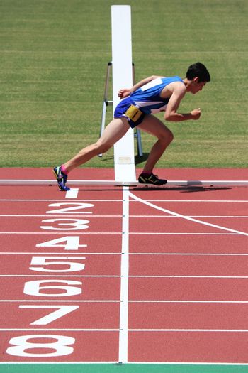 Full length of athlete running on sports track