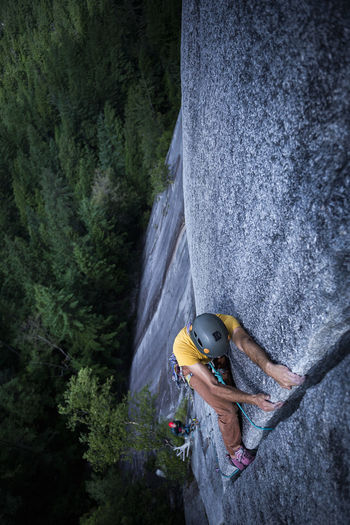 Man lay backing a wide crack high above ground on granite squamish