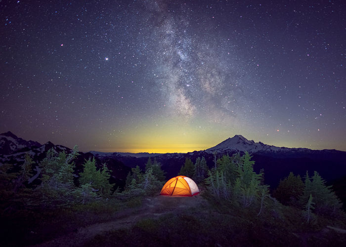 A tent is under the milky way on the top of a mountain, washington, us