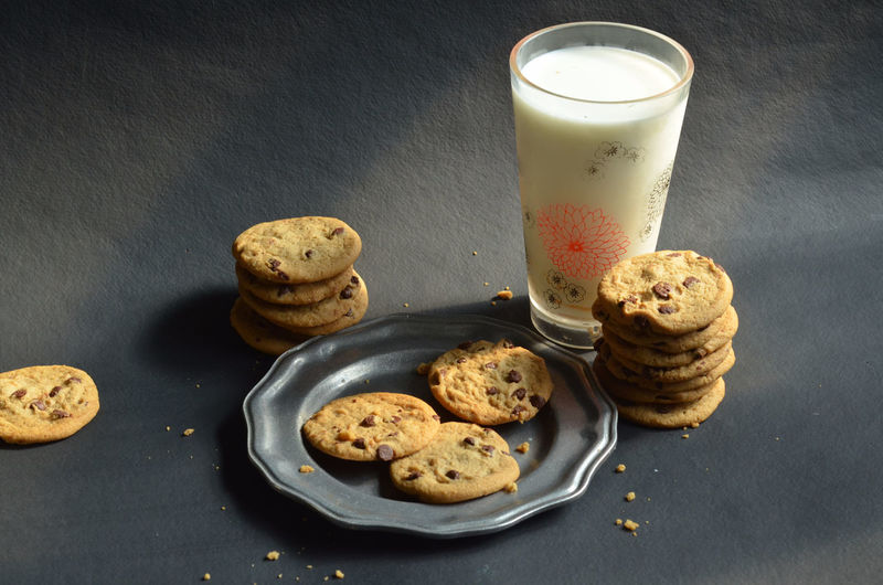 High angle view of chocolate chip cookies with milk