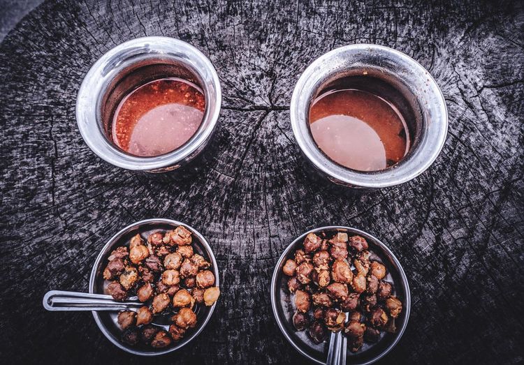 High angle view of hazelnuts and drinks on table