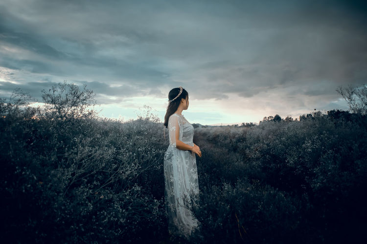 Woman standing on land against sky