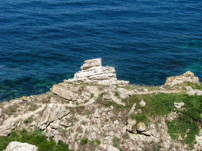 High angle view of rock formations at shore