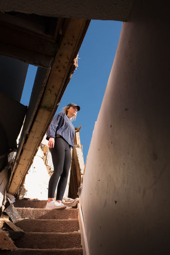 Girl standing in tornado destruction