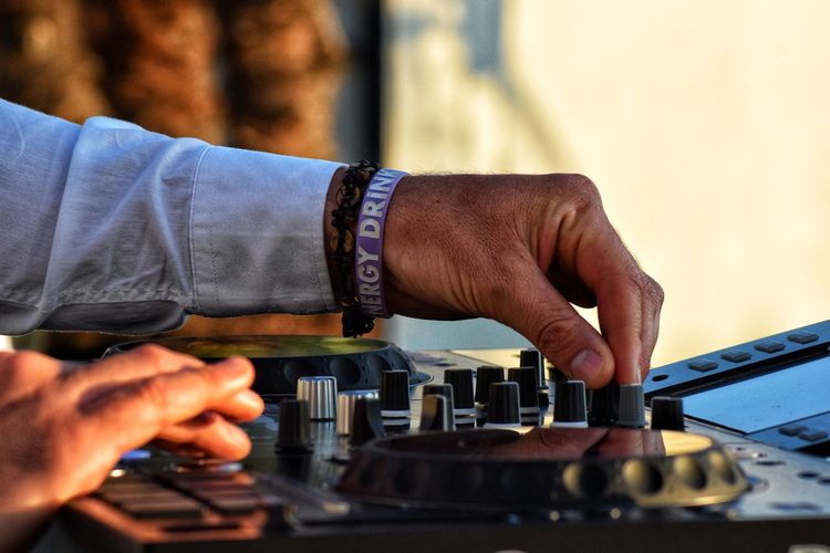 Cropped of hand playing turntable at concert
